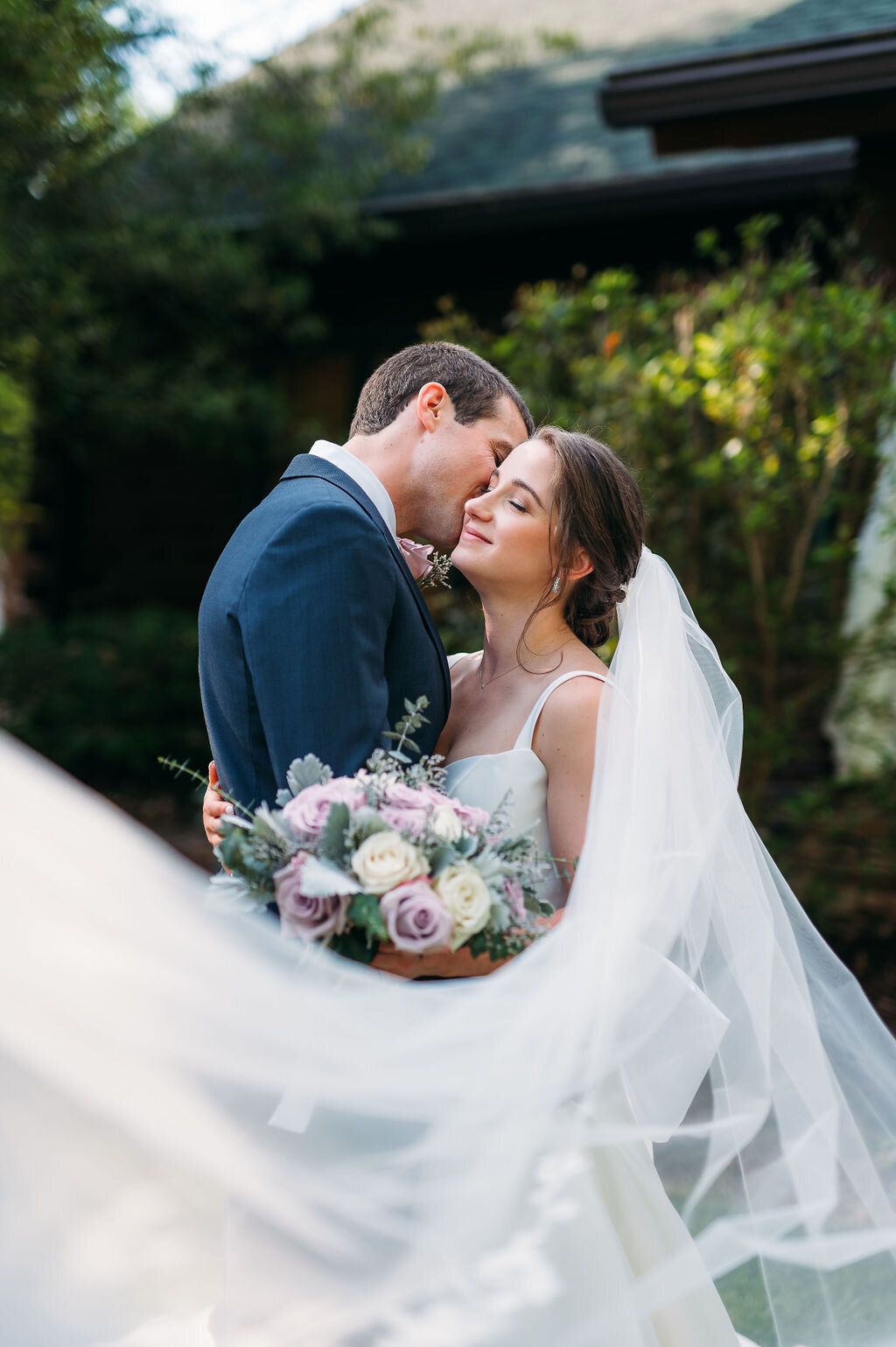 Bride and groom portrait with the bride's veil lifted at Three Birches wedding venue in Alpharetta, Georgia